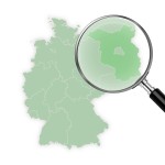 Deutschlandkarte - eine Lupe zeigt vergrößert das Land Brandenburg an.